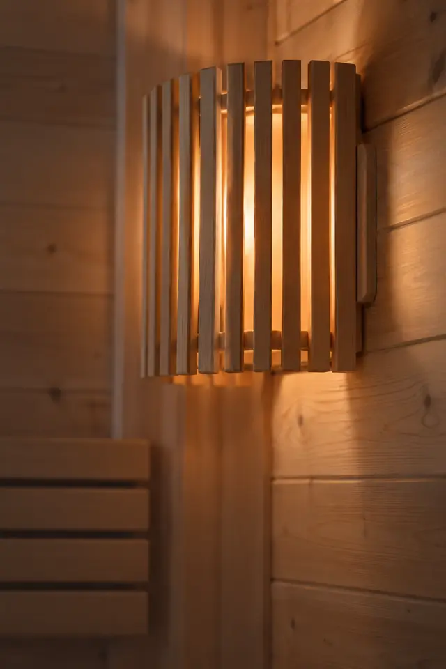Sauna lamp behind a wooden shade